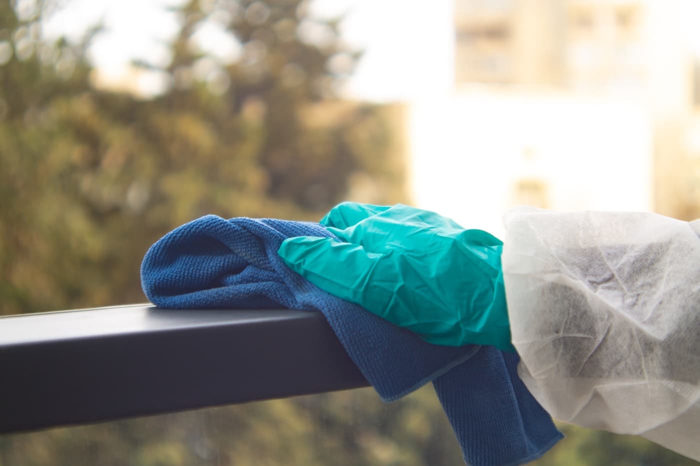A professional squeegeeing a window to a streak-free finish